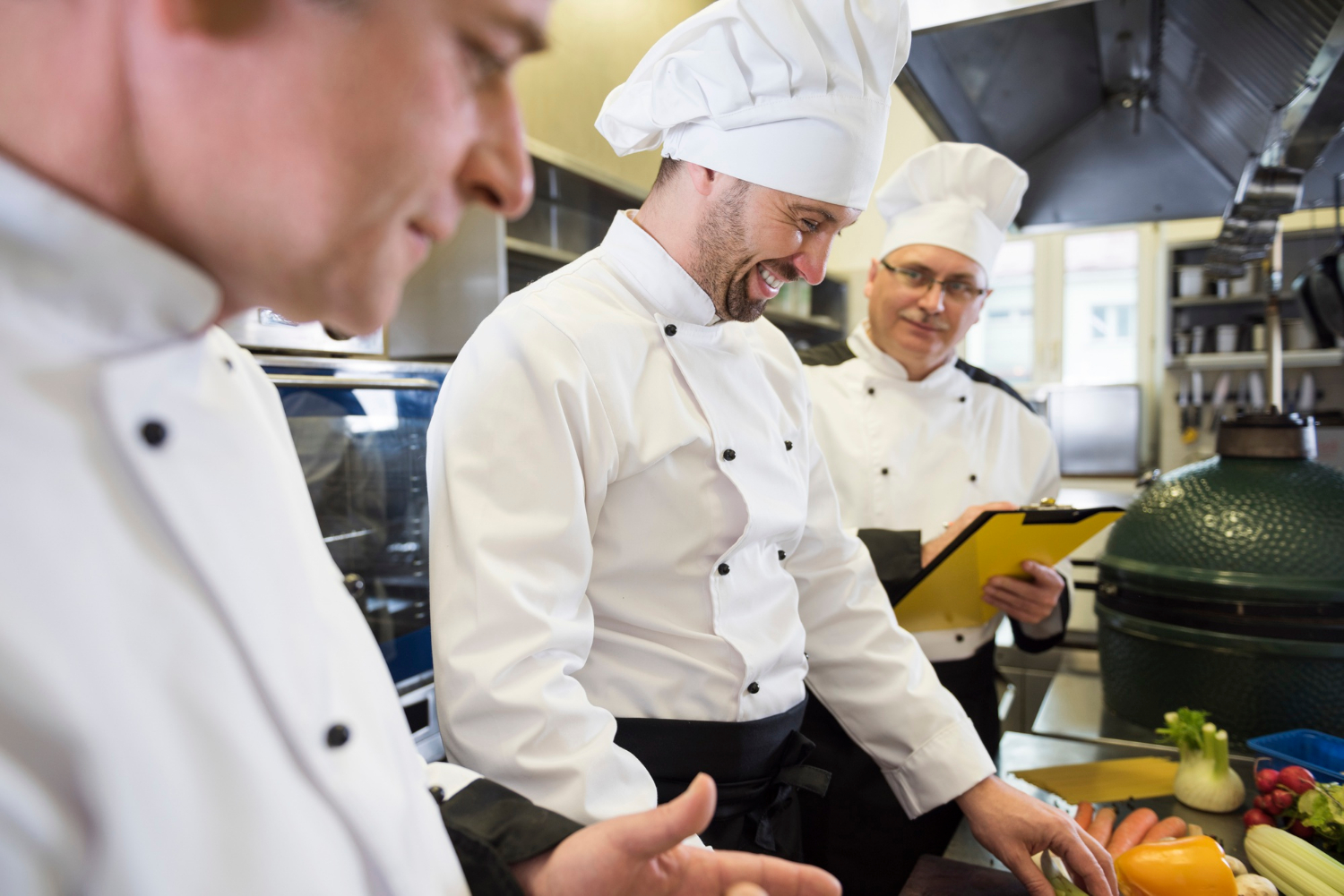Chef training a new kitchen employee in a restaurant